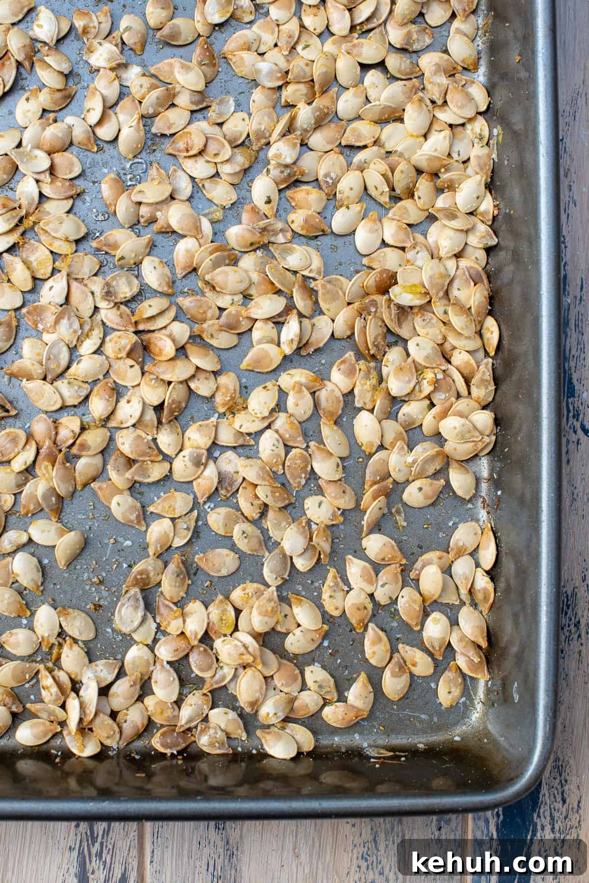 A top down shot of roasted acorn squash seeds on a baking sheet.