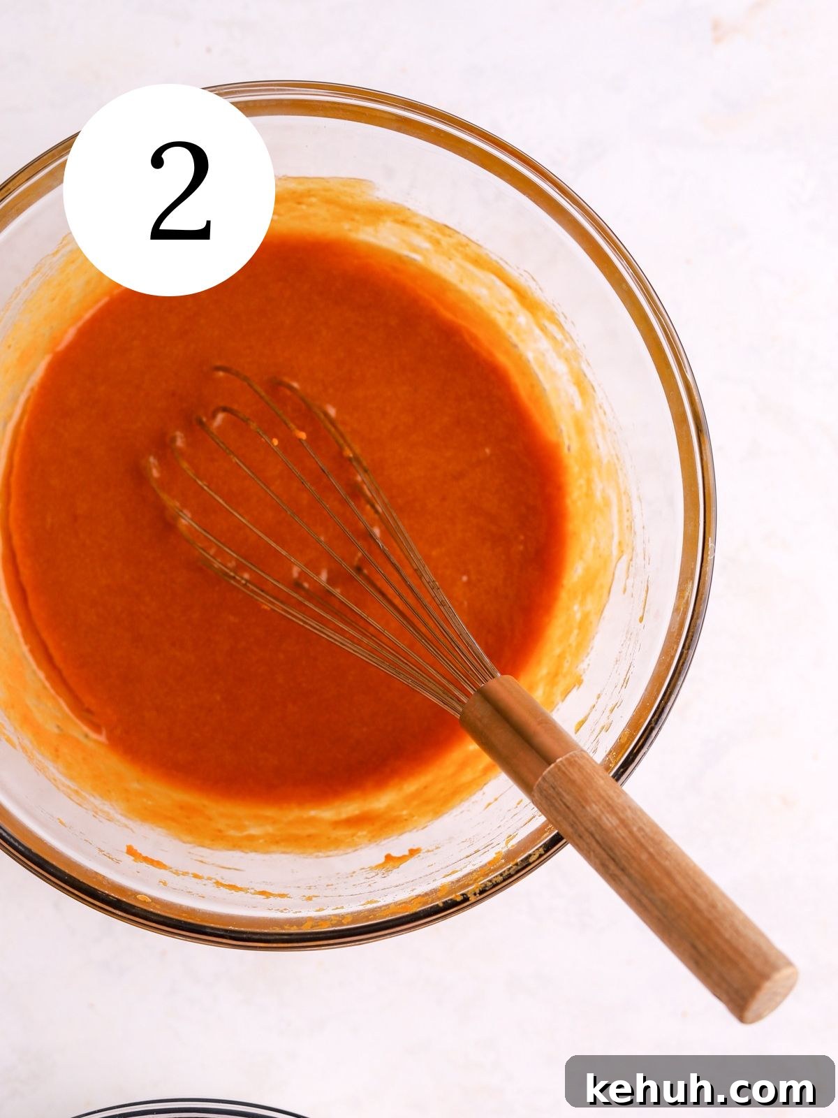 Moist Pumpkin and Carrot Layer Cake Recipe 5 A mixing bowl with pumpkin puree and other wet ingredients whisked together.