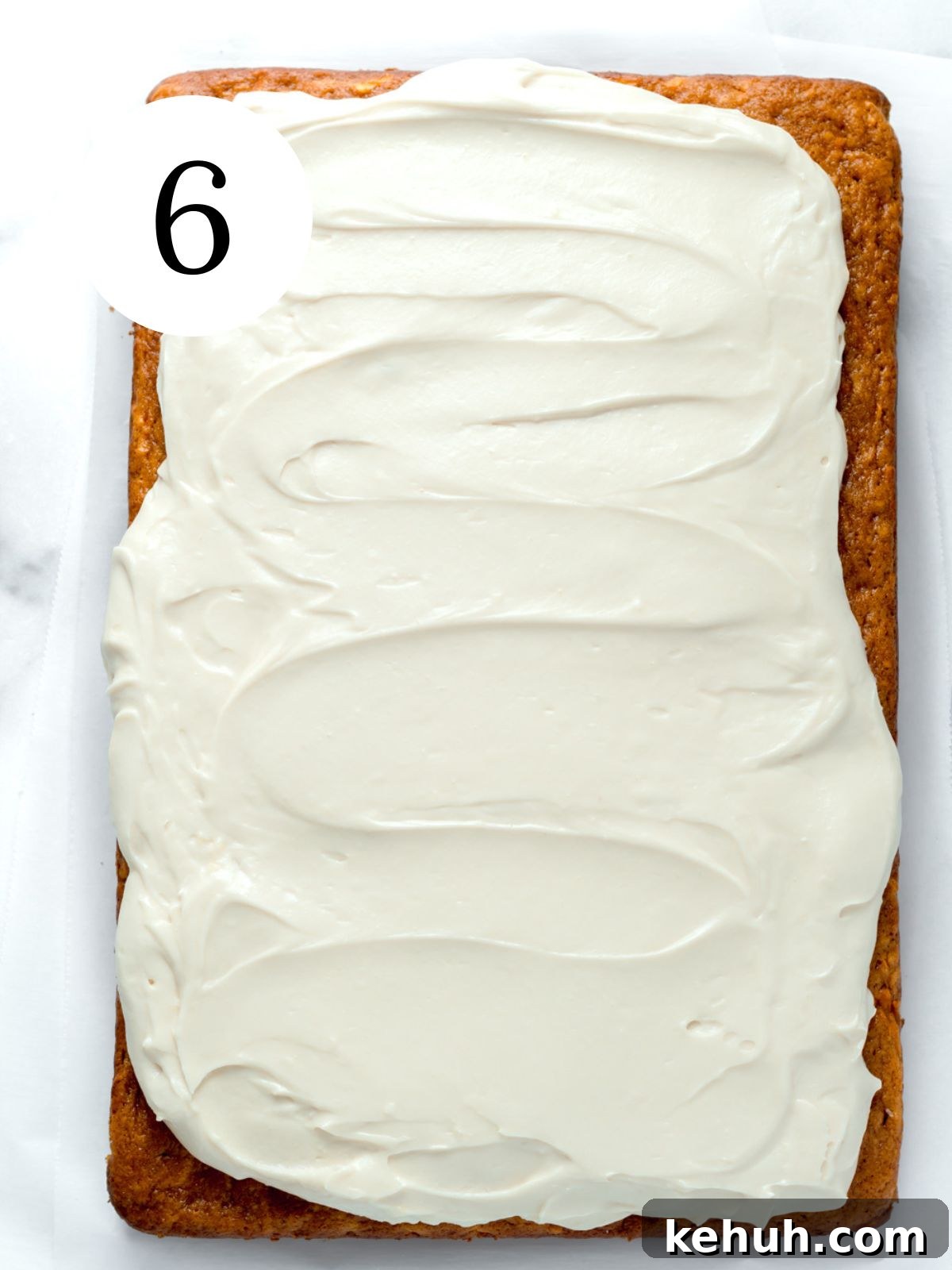 Moist Pumpkin and Carrot Layer Cake Recipe 9 A pumpkin carrot cake with frosting spread on top.