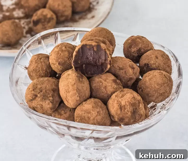 Champagne Truffle Recipe: How to Make Luxury Chocolate Truffles 4 champagne truffles in a glass cup, one truffle on top with a bite out of it