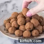 champagne truffles on a plate with a hand grabbing a truffle