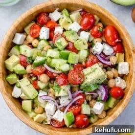 Mediterranean Chickpea and Feta Salad Recipe 11 top view chickpea tomato salad in a wooden bowl