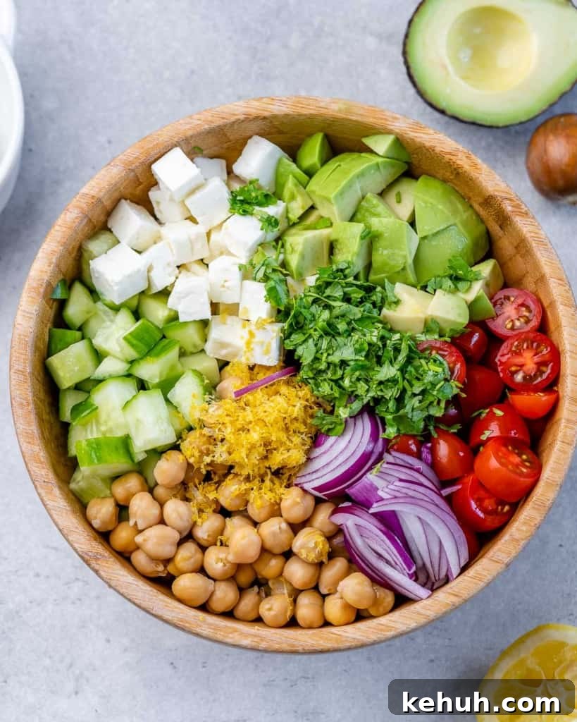Mediterranean Chickpea and Feta Salad Recipe 5 Chickpea Feta Salad ingredients individually placed in a wooden bowl (not mixed).