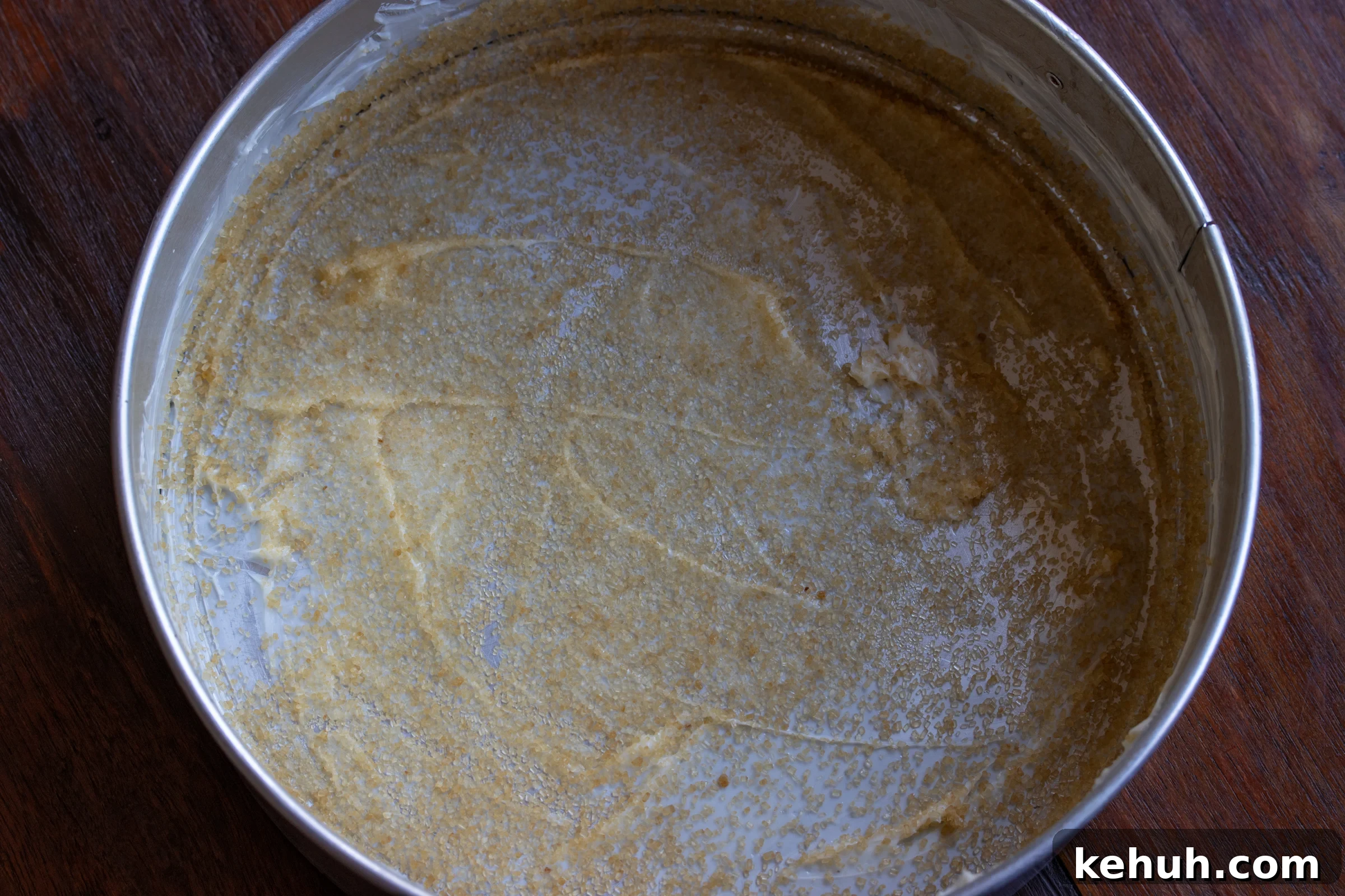 buttered springform mold and turbinado sugar sprinkled over it