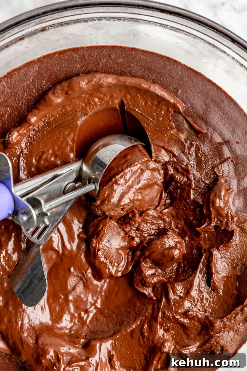 220824_Bourbon Pecan Truffles-13 Cookie scoop scooping chocolate ganache out of a bowl.