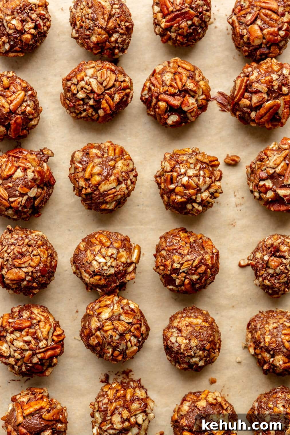 220824_Bourbon Pecan Truffles-18 Parchment lined sheet pan with rows of bourbon pecan truffle balls.