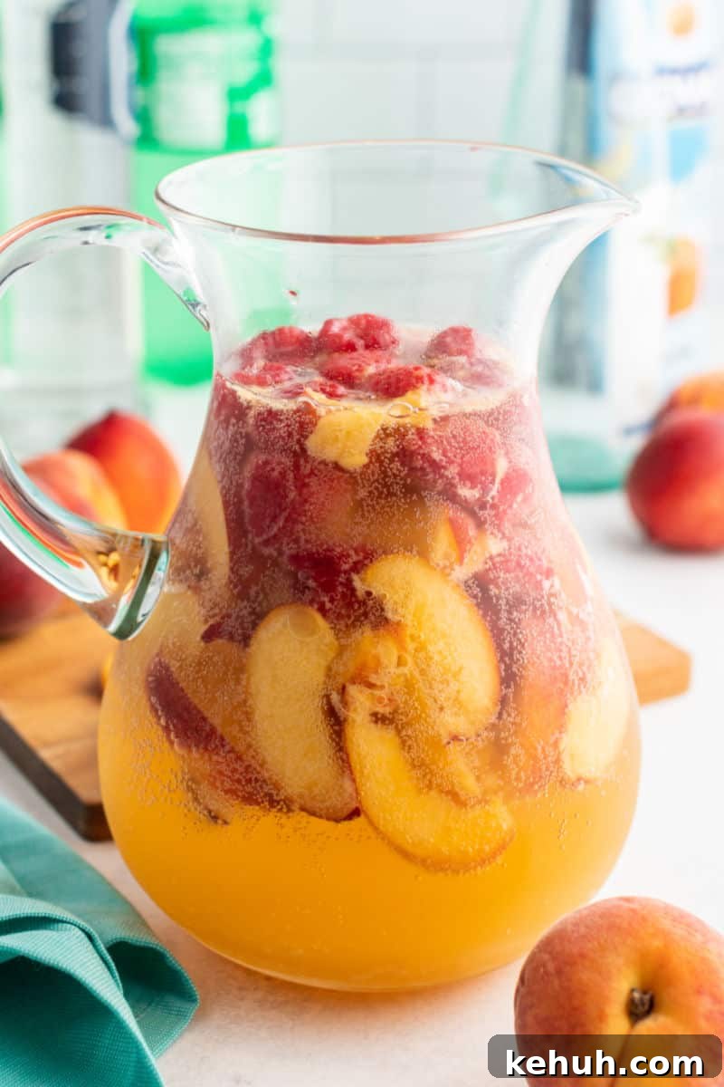 Bring on a never-ending pitcher of this Raspberry Peach Moscato Punch! Some wine, Sprite, and lots of fruit is a crazy good combo made for sharing! pitcher of raspberry peach moscato punch