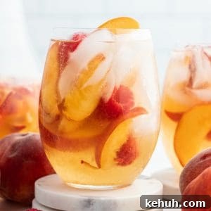 Raspberry Peach Moscato Punch Recipe for Summer Gatherings 2 cloe up of a glass of peach moscato punch with raspberries