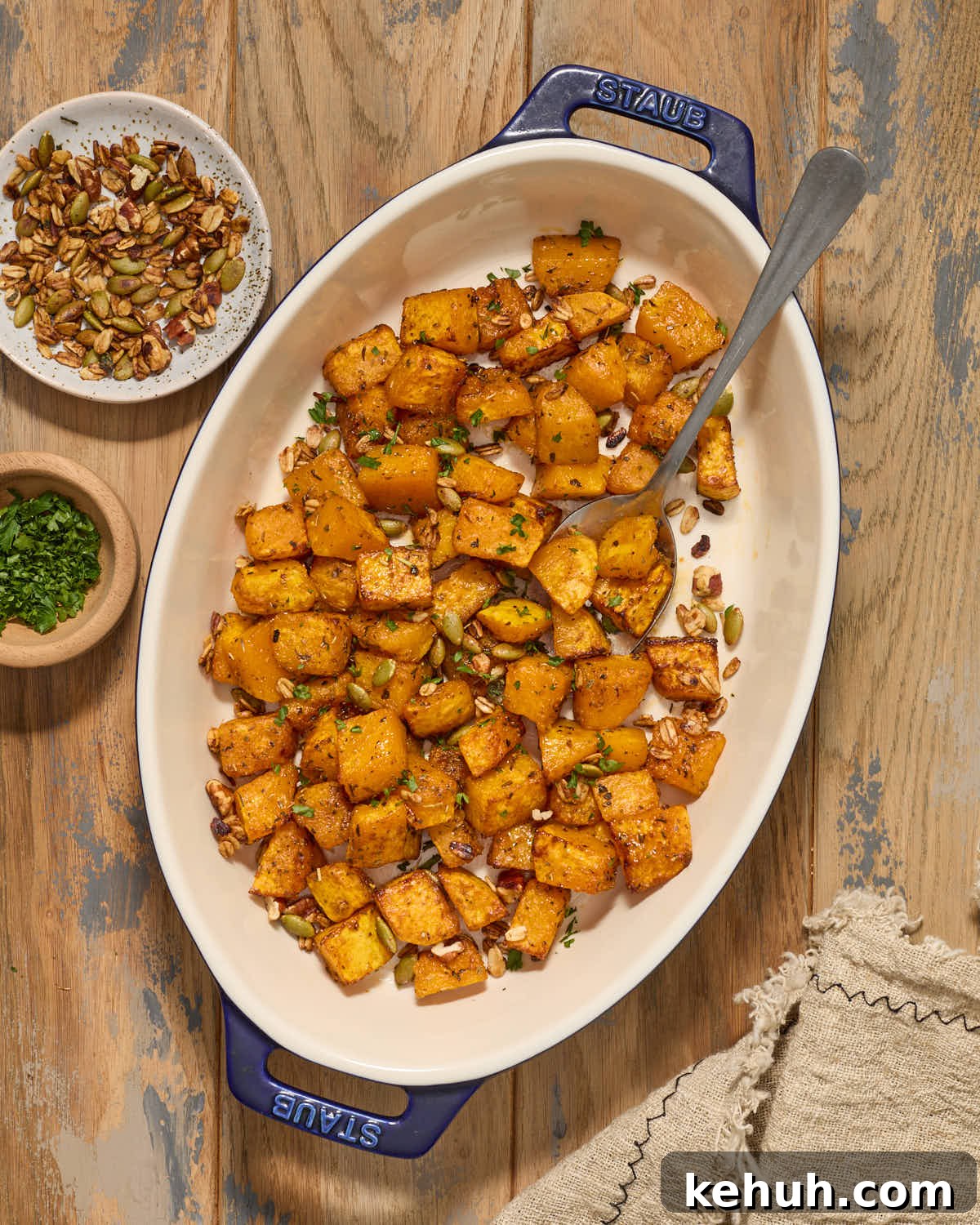 Squash cubes served in a dish with a spoon.
