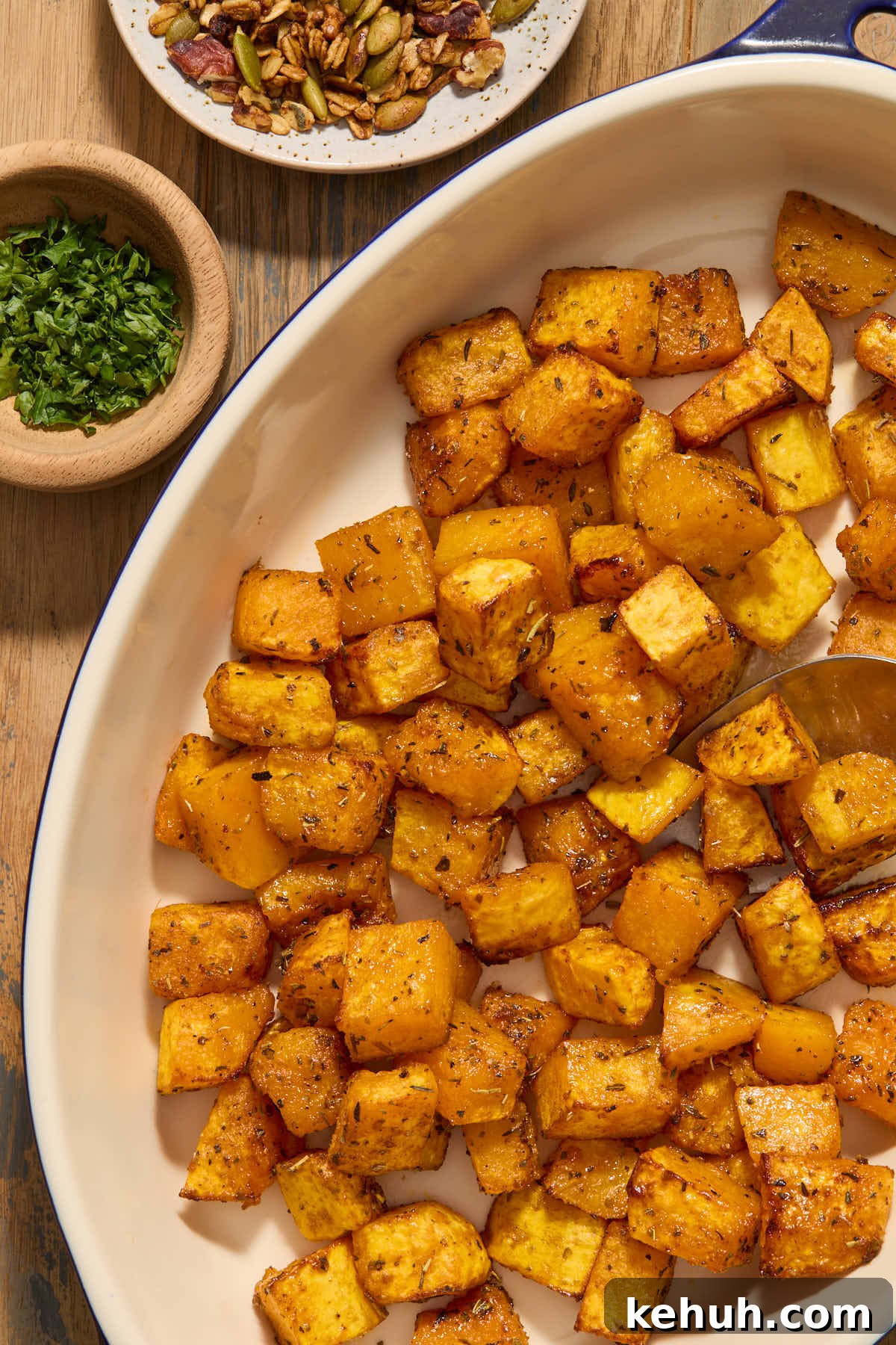 Close up of air fried butternut squash cubes in a serving dish.