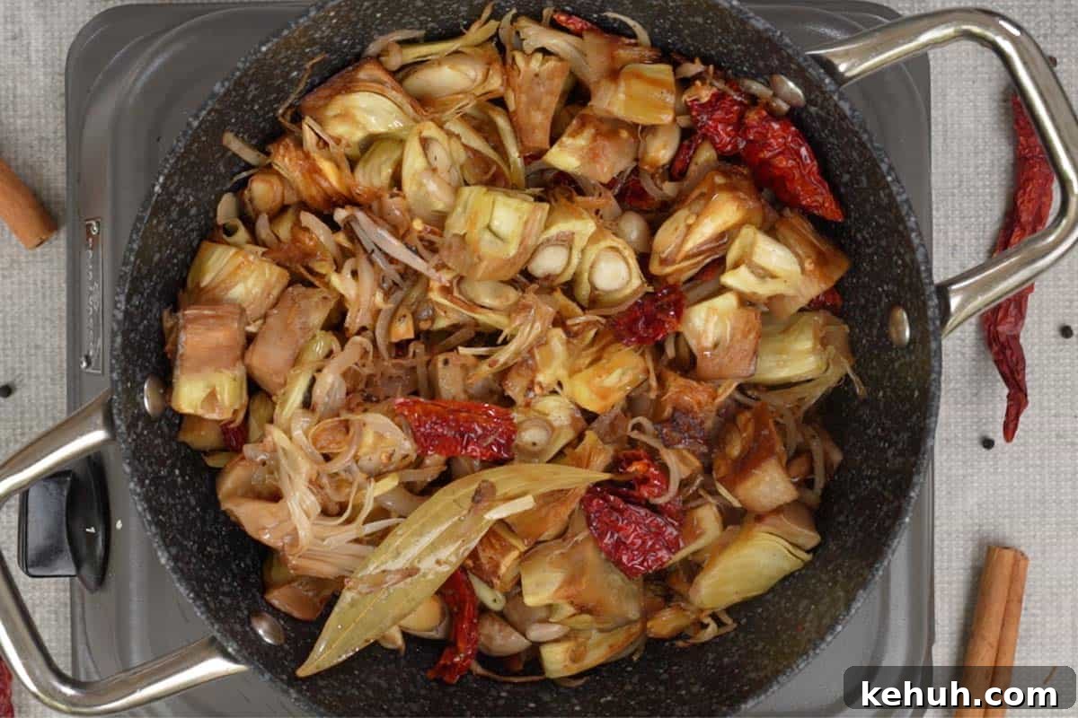 Fried kathal, salt and water added to the pan.