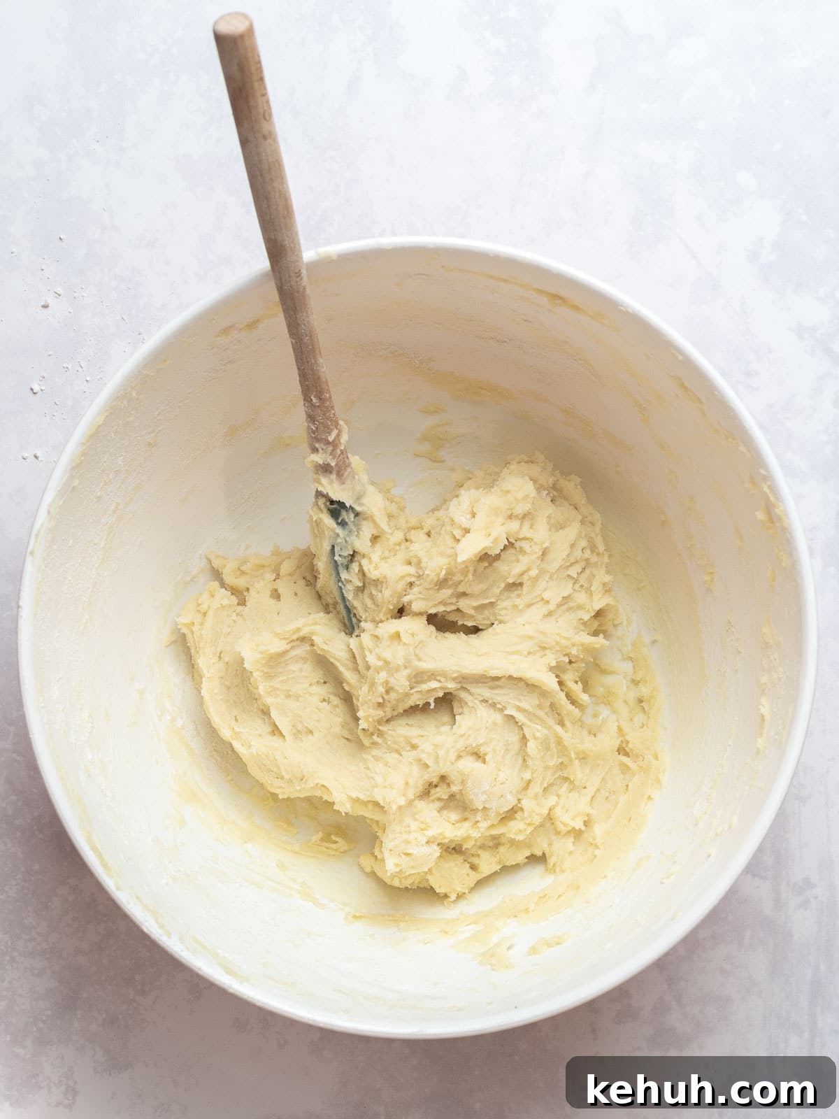 Classic Butter Cookies: Simple 6-Ingredient Recipe 3 butter cookie dough mixed in a mixing bowl with a spatula