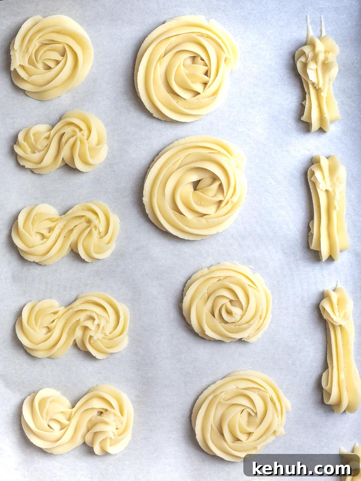 Classic Butter Cookies: Simple 6-Ingredient Recipe 6 butter cookies piped into different shapes on parchment paper