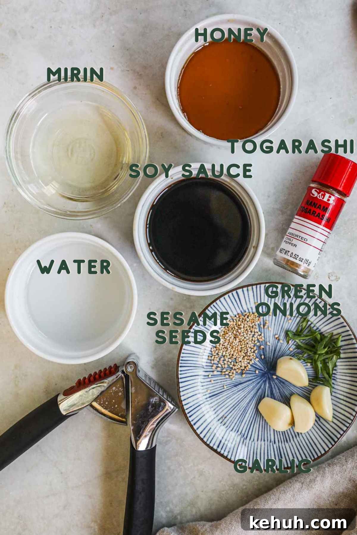 Ingredients to make honey soy garlic sauce, including mirin, honey, soy sauce, togarashi or chili flakes, water, and minced garlic.
