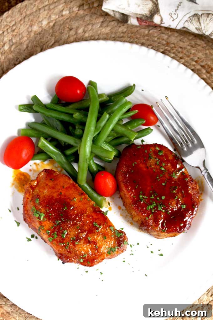Baked pork chops served on a white plate.