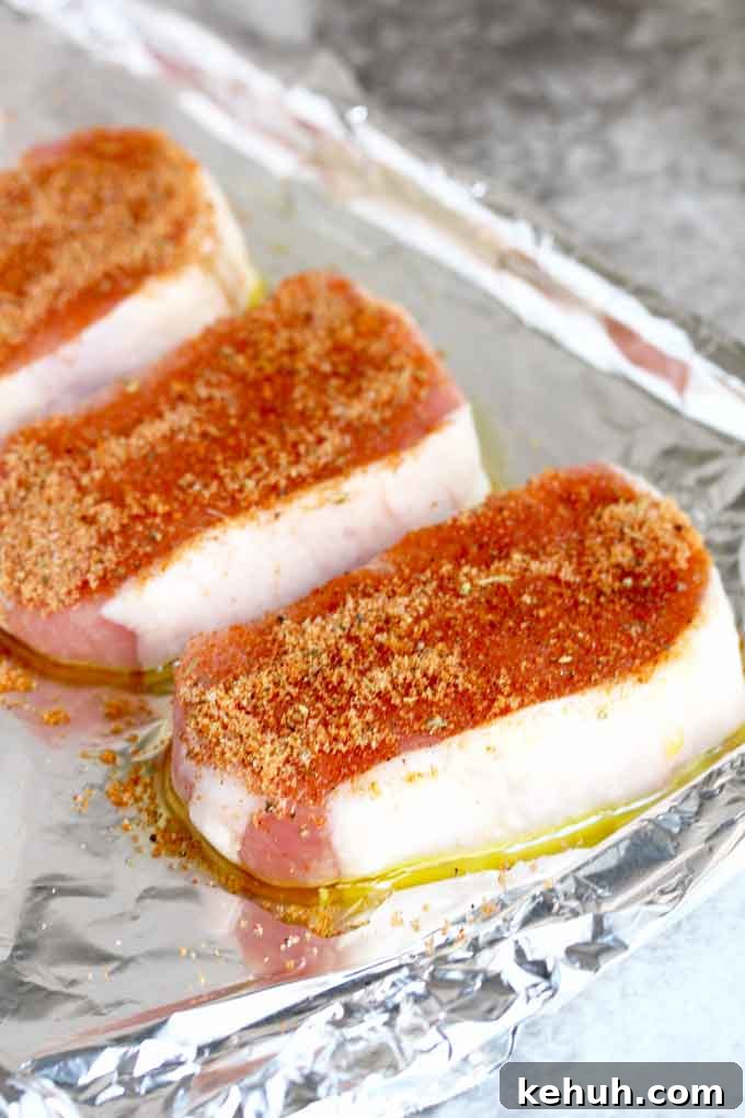 Pork chop seasoned on one side with dried rub.