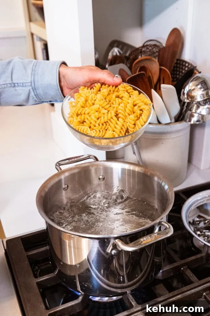 Cheesy Pizza Casserole Recipe with Sausage and Peppers 5 Pasta gets placed into boiling water.
