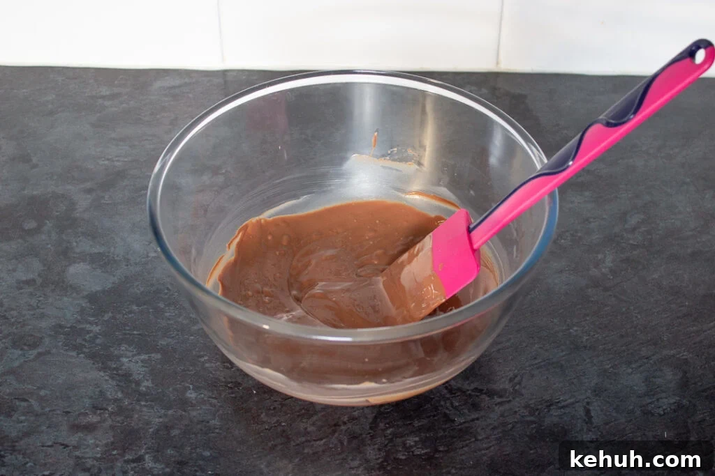 Melted chocolate in a glass bowl.