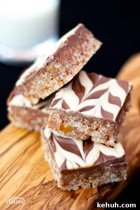Five bars of Mars Bar Slice on a wooden board.