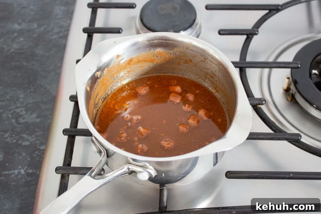 Mars Bars, butter and golden syrup melting in a saucepan.