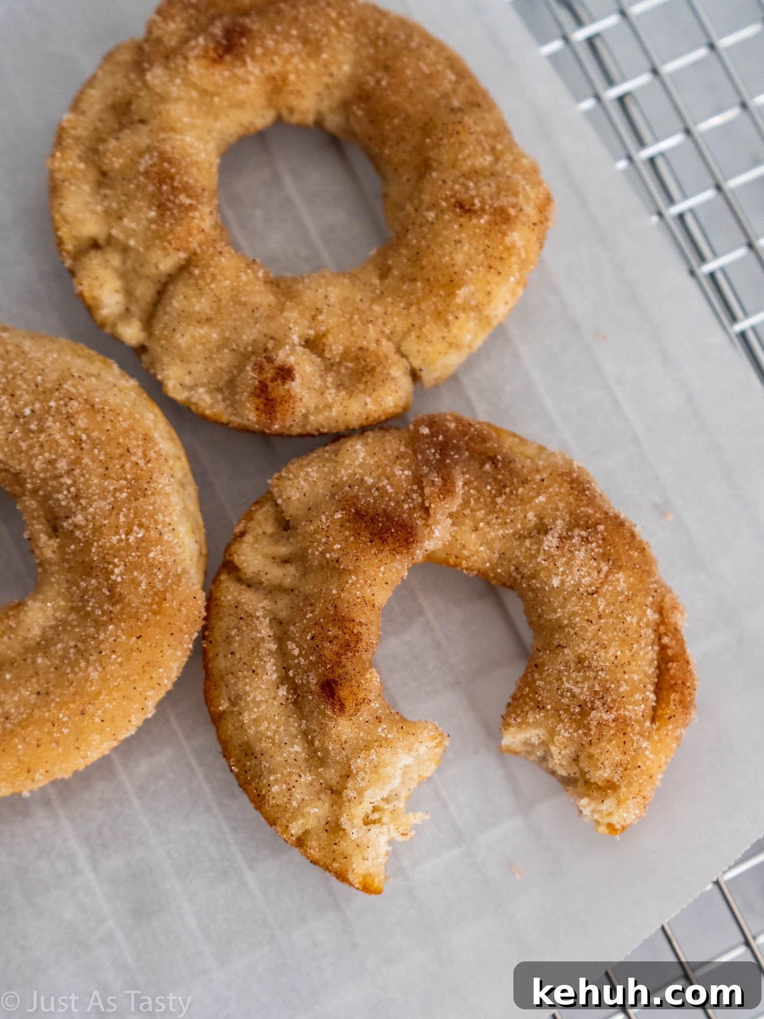 Gluten-Free Eggless Cinnamon Donuts Recipe 3 Close-up of a donut with a bite taken out of it.