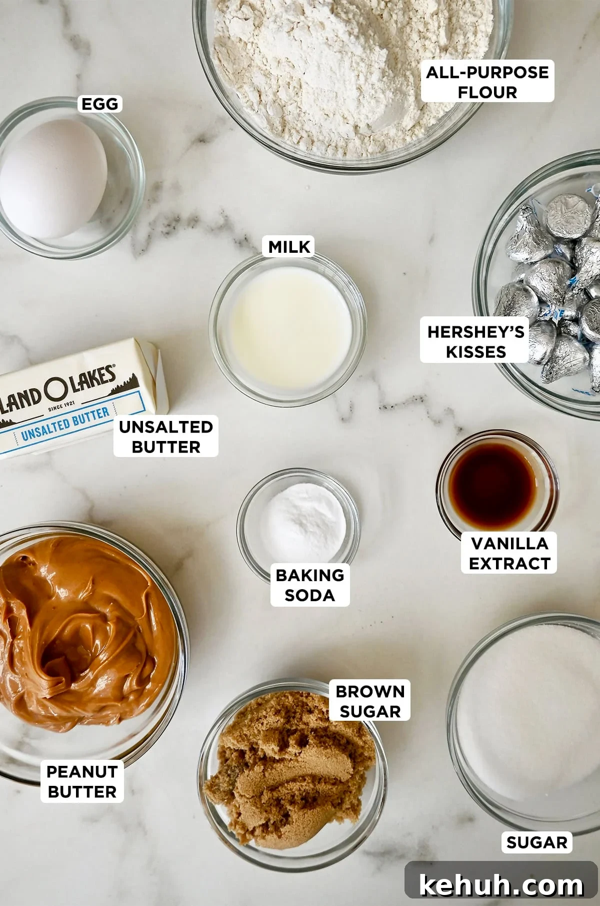 The ingredients needed to make peanut butter blossoms in various sizes of glass bowls.