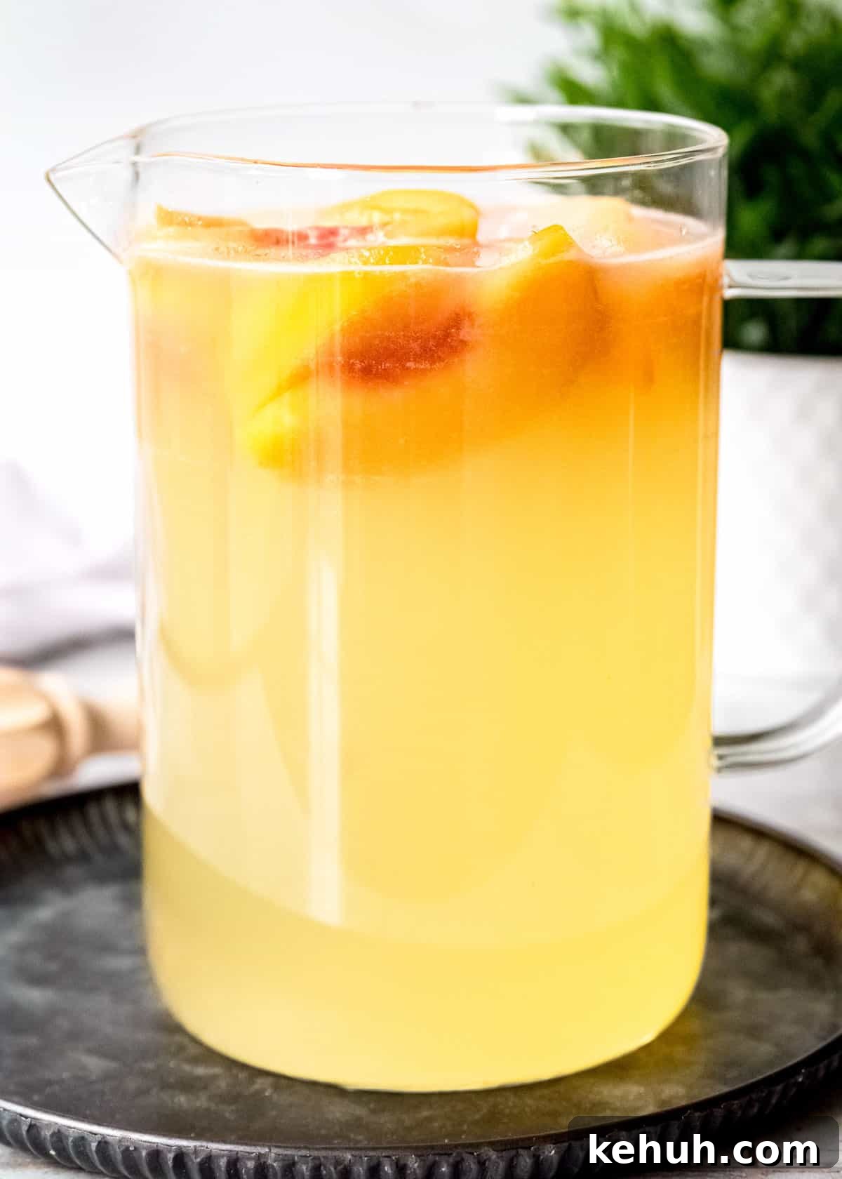 Peach Bourbon Lemonade Recipe — Refreshing Summer Cocktail 10 a large pitcher of peach lemonade with peach schnapps and bourbon