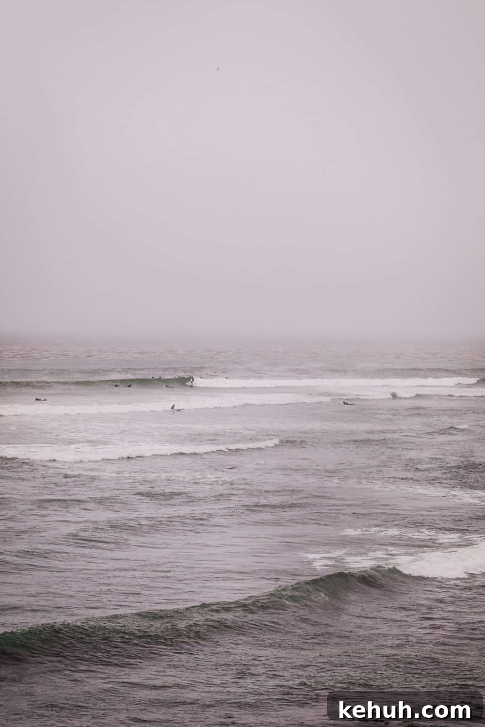 A view of surfers out on the line up in Pleasure Point on a foggy day