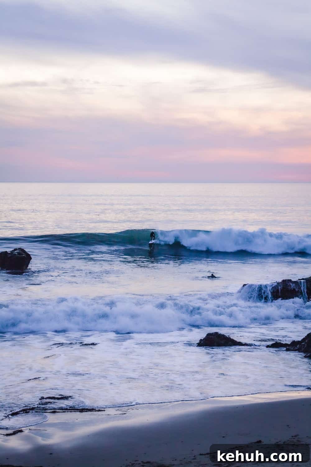 A surfer getting into a wave in Santa Cruz