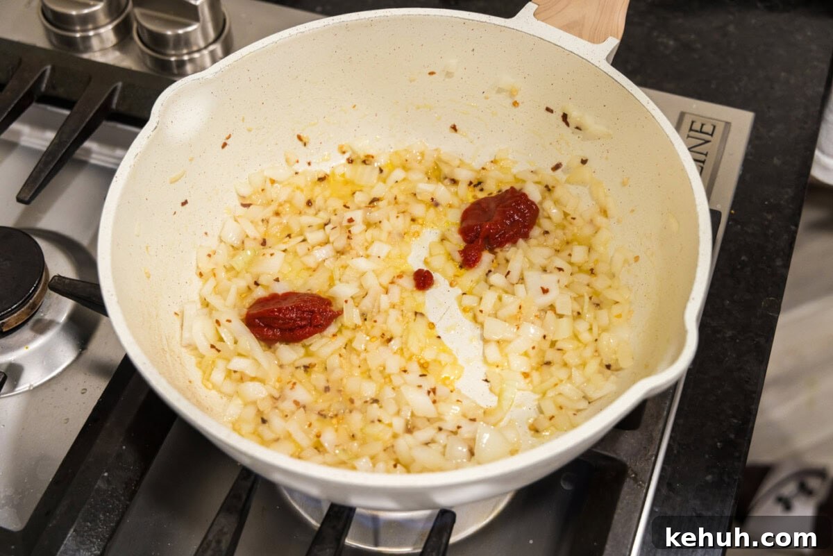 Creamy Vodka Sauce Recipe for Pasta 6 tomato paste added to skillet of onion mixture