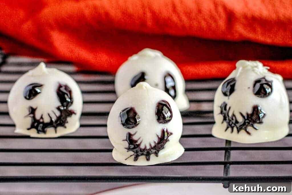 Four pieces of Skeleton Oreo Cookie Balls on a rack.