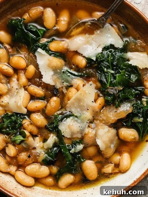 Creamy Roasted Butternut Squash Soup with Sage and Garlic 11 A bowl of brothy beans with greens and shaved cheese on top.