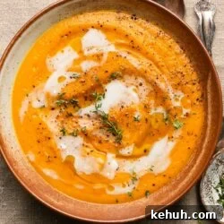 Creamy Roasted Butternut Squash Soup with Sage and Garlic 14 Creamy butternut squash soup garnished with fresh thyme and black pepper.