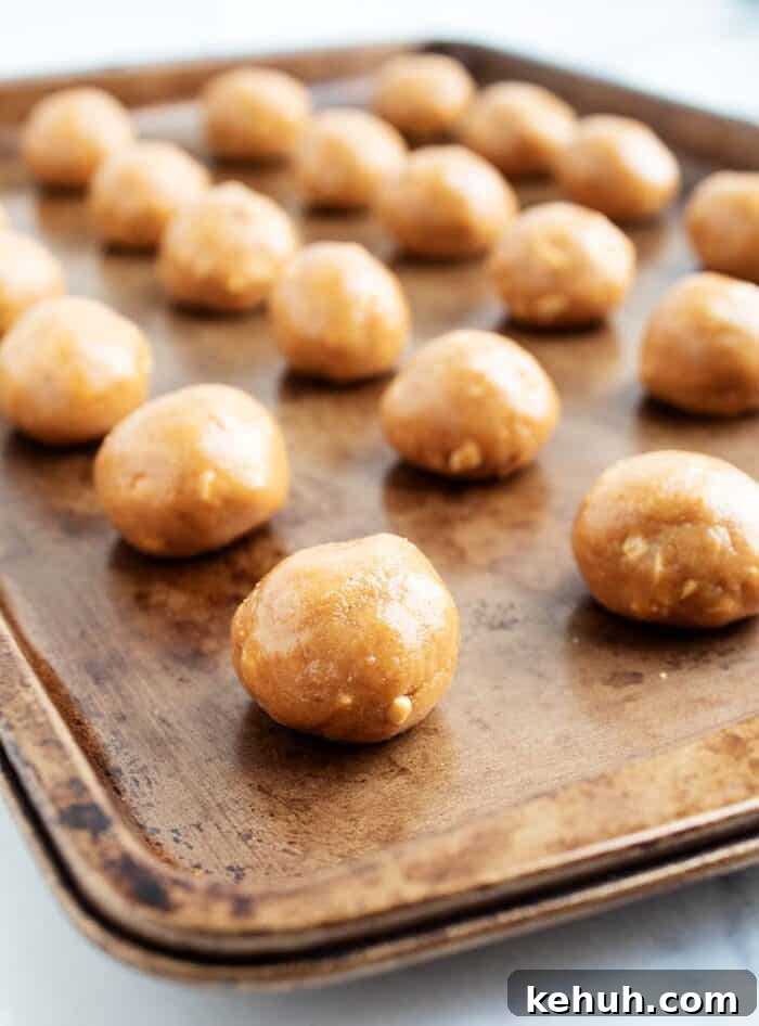 Keto Peanut Butter Chocolate Chip Cookie Bars 11 3 ingredient peanut butter balls lined up on a baking tray