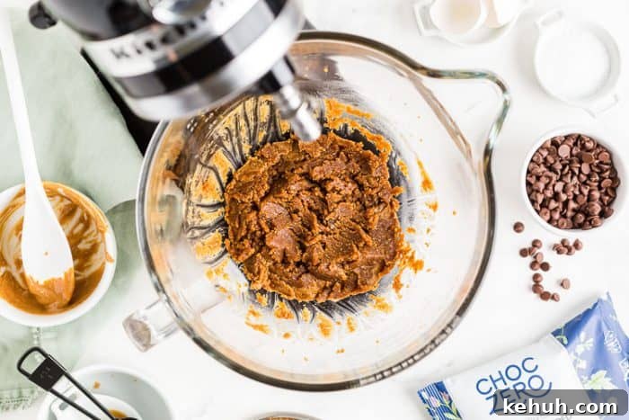 Keto Peanut Butter Chocolate Chip Cookie Bars 3 stand mixer containing peanut butter cookie bar batter